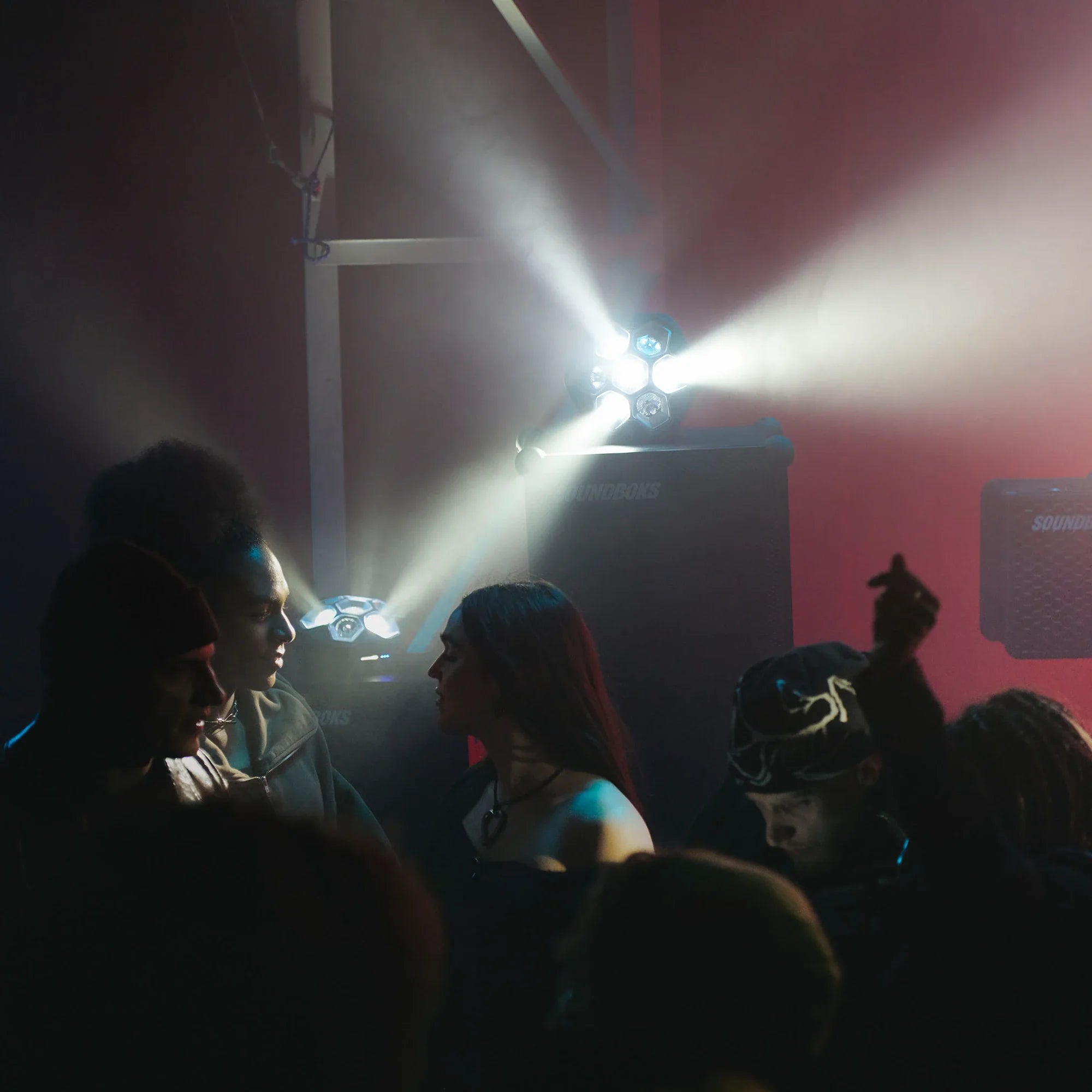 People at a concert with soundboks and lightboks in the background
