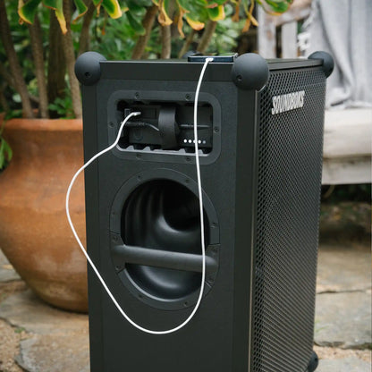 Smartphone getting charged with soundboks The Battery while playing